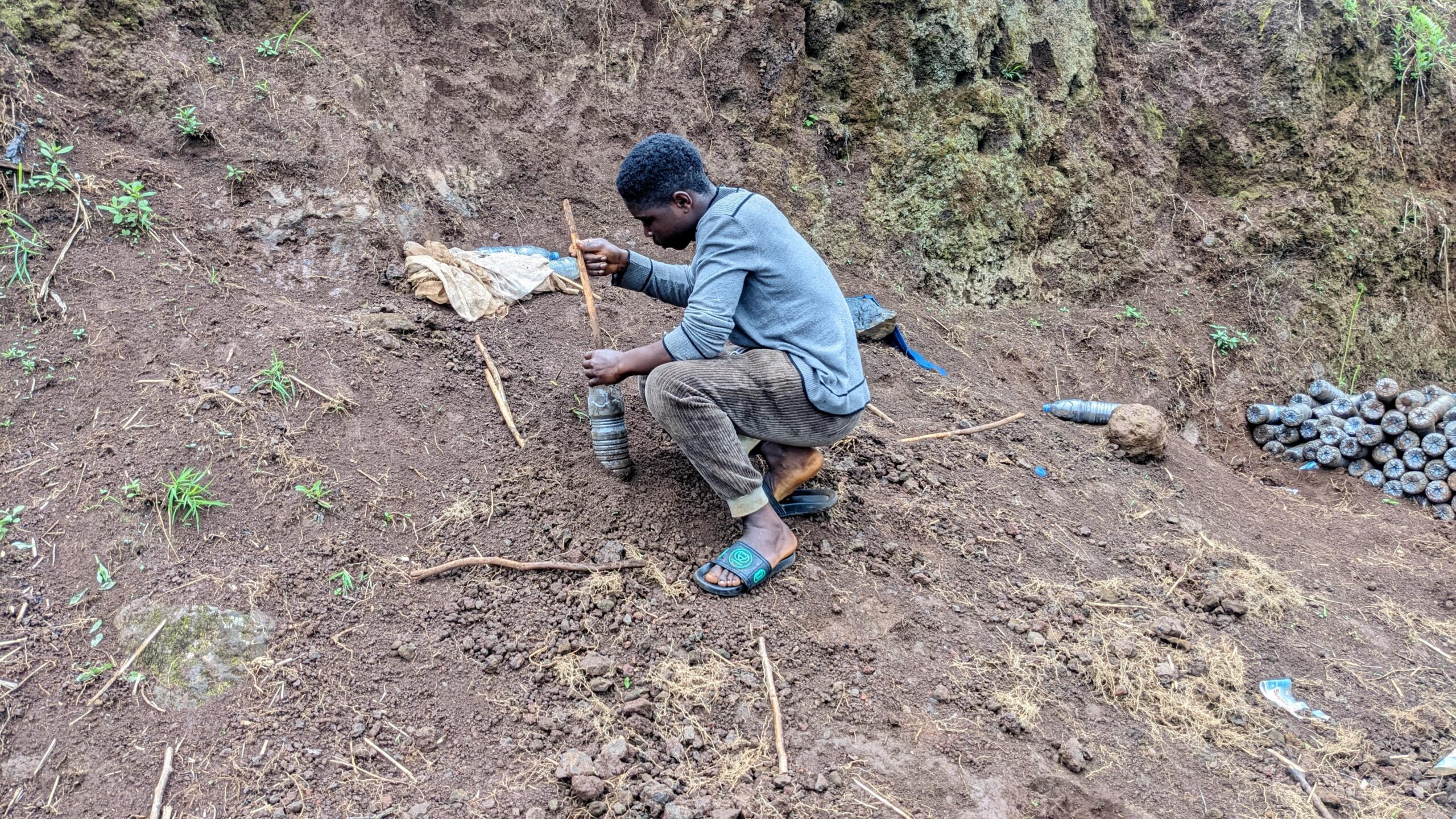 Filling plastic bottles with soil